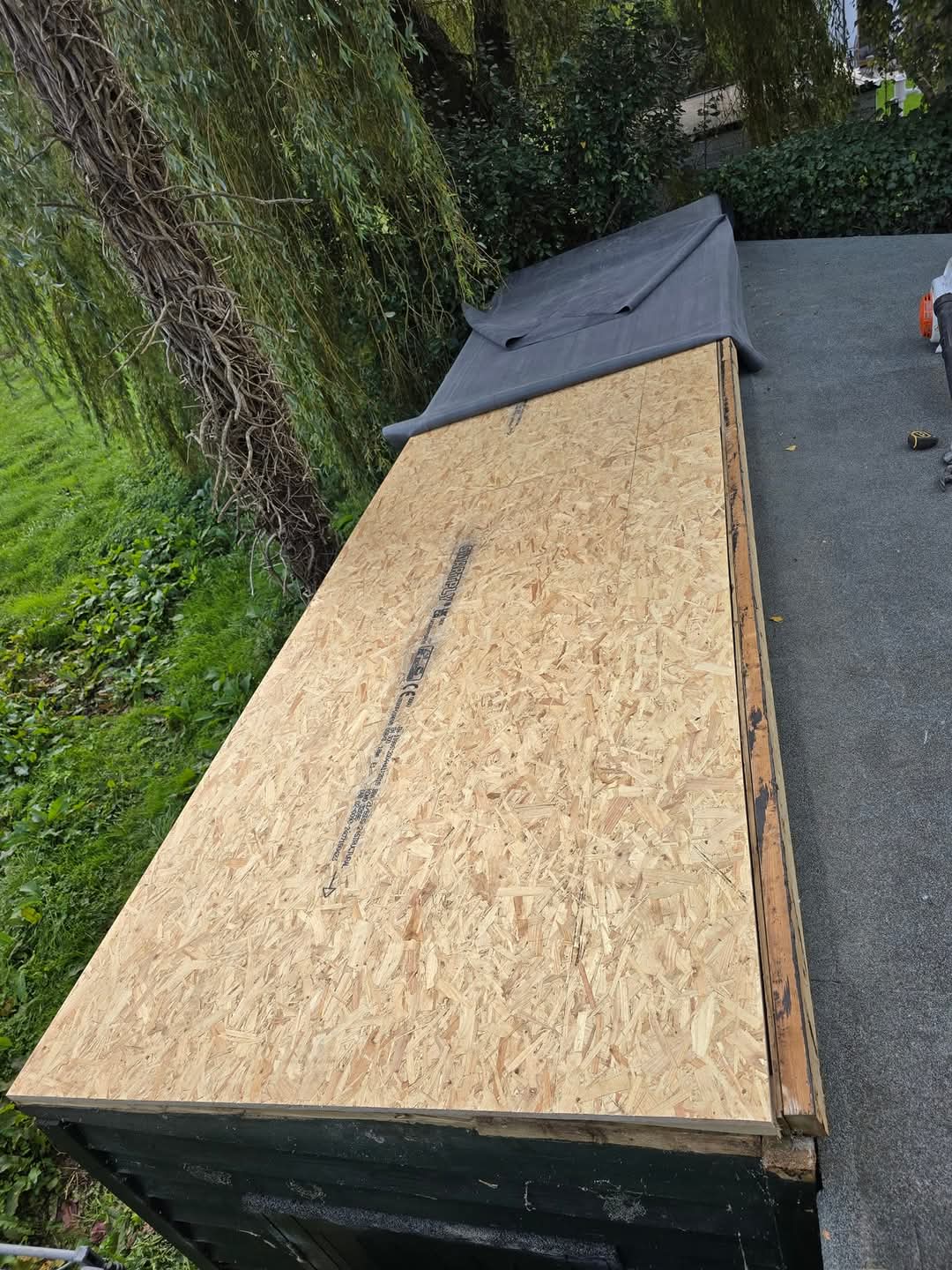 New Deck — Fresh 18mm OSB boards laid and sealed.