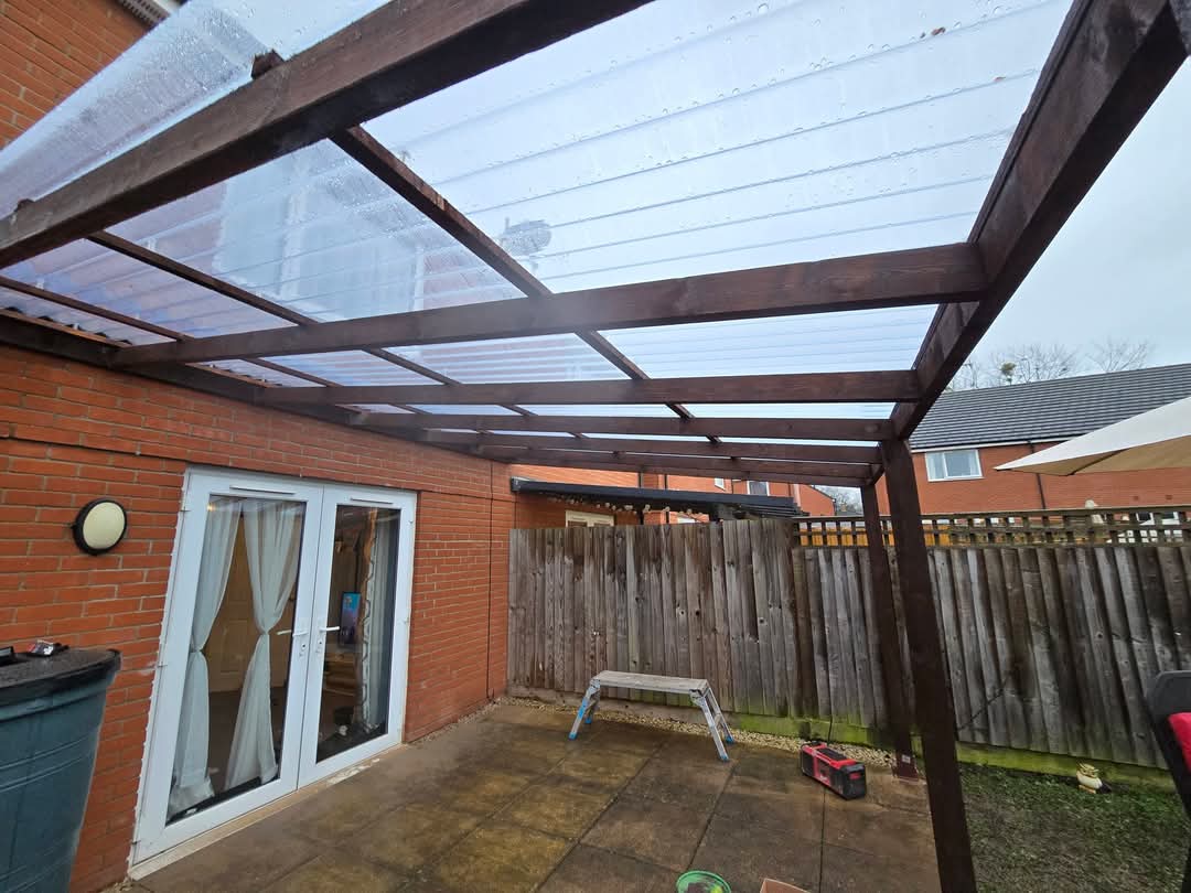 Finished timber lean-to with clear polycarbonate roof