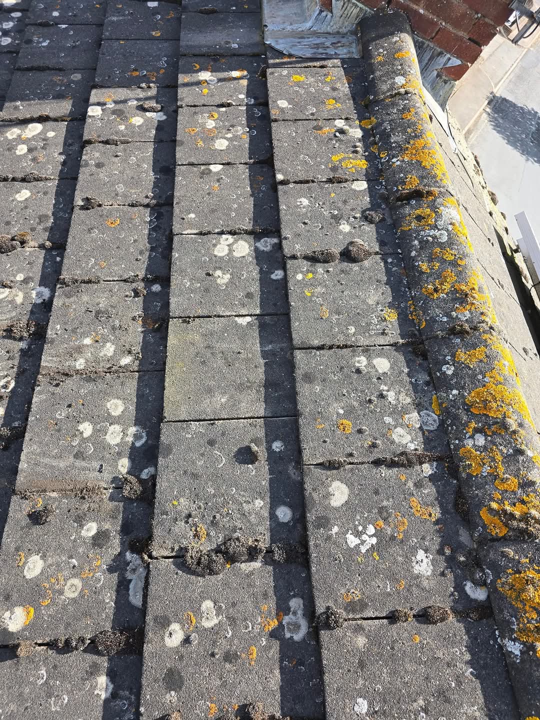 Aged tiles inspected for replacement